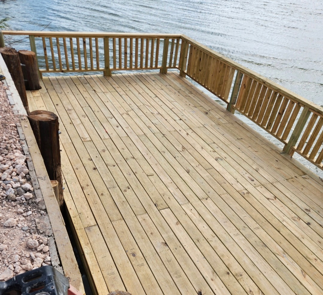 Completed waterfront deck with railing overlooking the water
